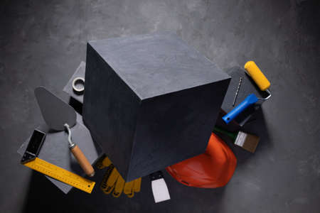 Cement cube and construction block at cement floor. Tool and construction concept on concrete...