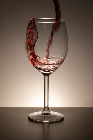 Pouring vine into a vine glassの写真素材