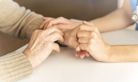 A young nurse shows care and professionalism in relation to an elderly woman
