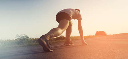 Young man is running, training outdoor at suset.