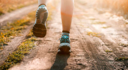 Young girl is running at sunset.の写真素材