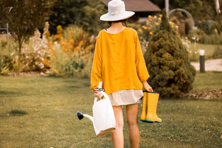 Woman in vintage style hat is gardening.の写真素材