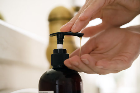 Girl washes her hands with soap.の写真素材