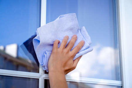 Girl is washing and cleaning the windows.の写真素材