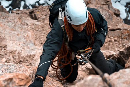 Climber is rappeling from the mountains summit.