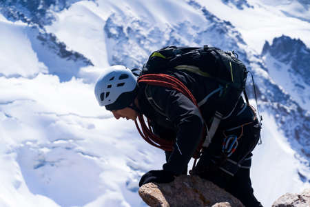Man is hiking, climbing in the beautiful mountains.