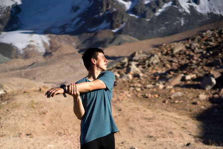 Man is warming up before running outdoor.