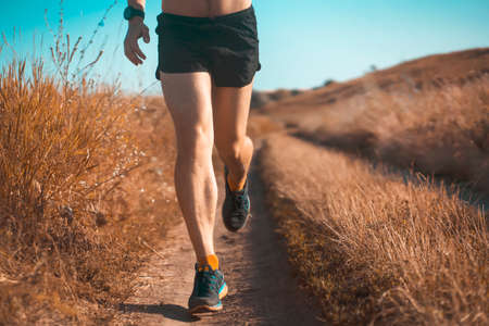 Man is training, running, warming up outdoor.の写真素材