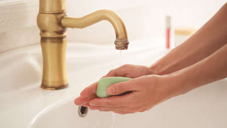 Woman is washing her hands.