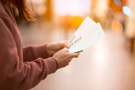 Girl holds tickets, boarding passes for a flight.の写真素材