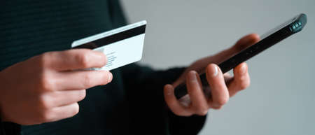 Girl is using online banking via smartphone.