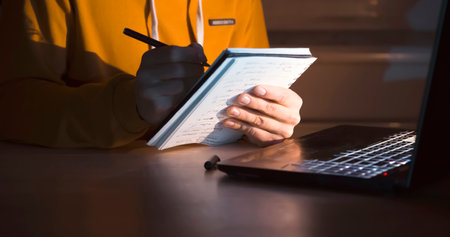 Man is working on a laptop at night.の写真素材