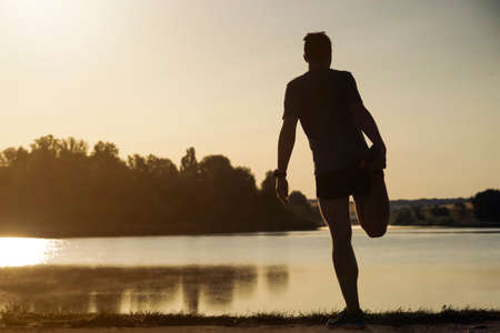 Man is training, running, warming up outdoor.の写真素材