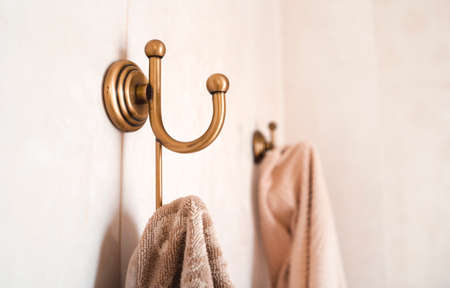Bathroom hooks with towels on the wall.の写真素材