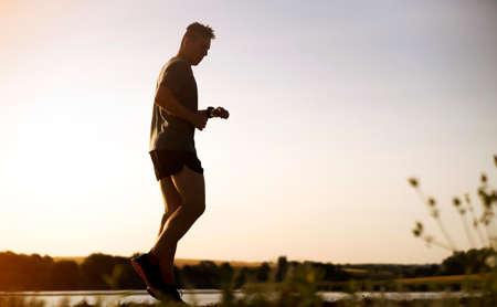 Man is training, running, warming up outdoor.