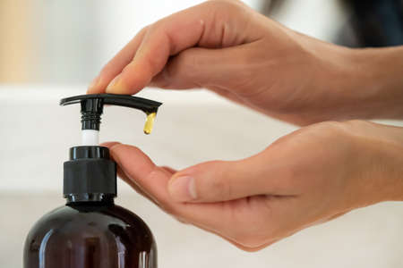 Girl washes her hands with soap.