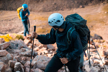People are climbing, hiking in the rocky mountains.