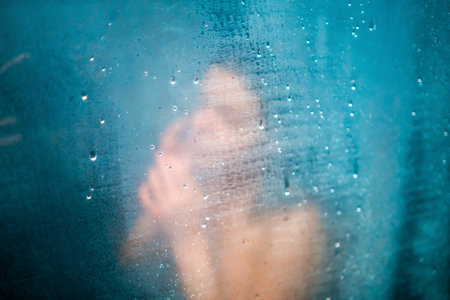 Girl takes a shower, washes her hair.の写真素材