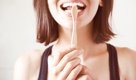 Girl takes care of her health, cleans her teeth.の写真素材