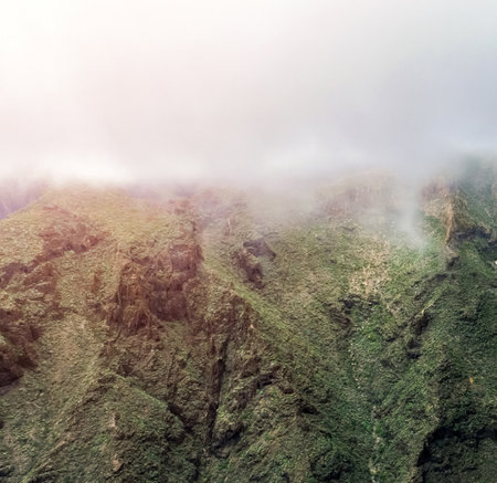 Green mountains and rocks in a foggy weather, scenic landscape with no people.の写真素材