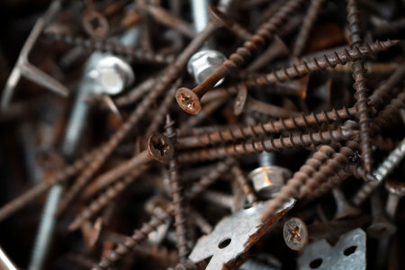 Nails and screws on the dark background, closeup view.の写真素材