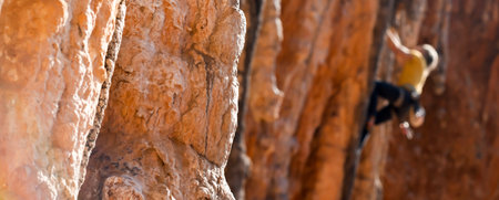 A man is climbing on the rocks in the mountains.の写真素材