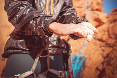 Girl is climbing with magnesium powder on the rocks.の写真素材