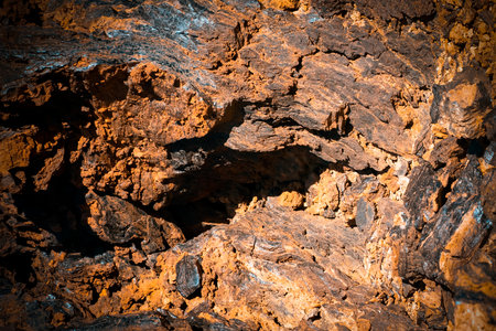 Lava formations, stones, black basalt in the rocks closeup on a volcano terrain.
