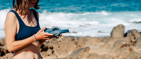 A girl with a wireless headphones, is listening music outdoors.