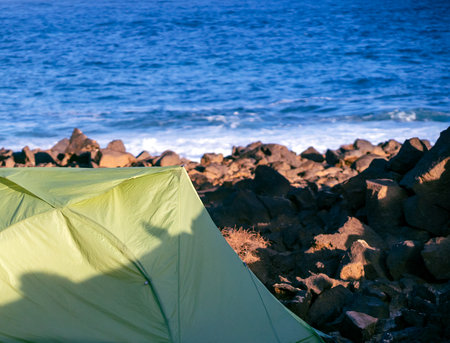 A tent for travelling and camping on the ocean coast background.の写真素材