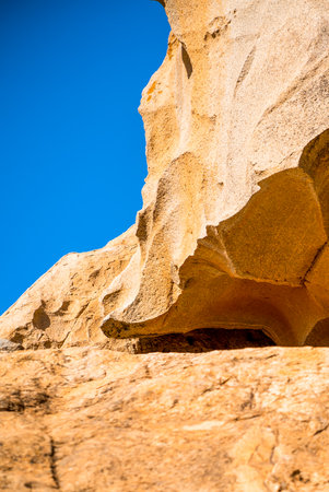 A rock, desert sandy formations, a natural arch Arco de las Penitas in the daylight.の写真素材