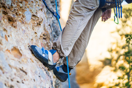 A woman is engaged in active extreme sports, mountaineering and climbing.の写真素材