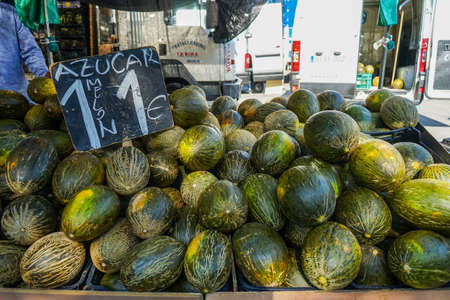Street market in Madrid, Spain. Melons and the price in a slate board.のeditorial素材