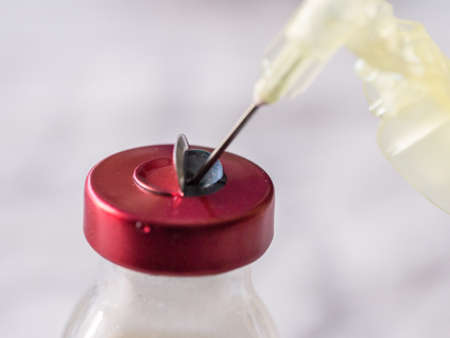 Bottle with the medicine and an a syringe. Macroの写真素材
