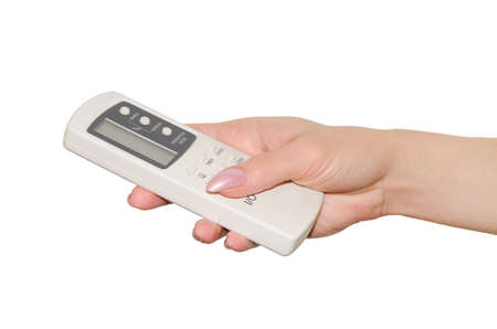 Remote control for air conditioner in a female hand, isolated on white background.