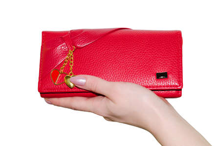 Red purse in a female hand isolated on white background.の写真素材
