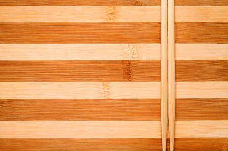 Chinese bamboo chopsticks closeup striped wooden background.の写真素材