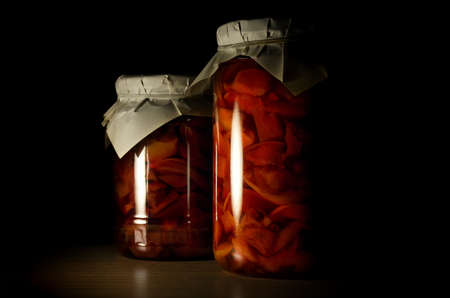 Two jars of apple jam closeup on a dark backgroundの写真素材