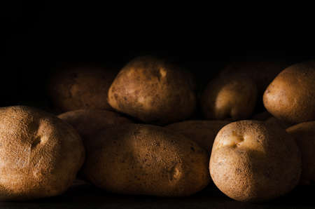 Fresh raw potato close-up on a dark backgroundの写真素材