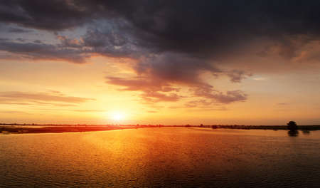 Lake Panorama in the morning at sunrise with cloudsの写真素材