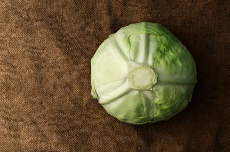Fresh raw cabbage with drops of water close-up on a background of burlapの写真素材