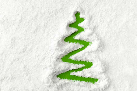 Green Christmas tree drawn on white snowの写真素材