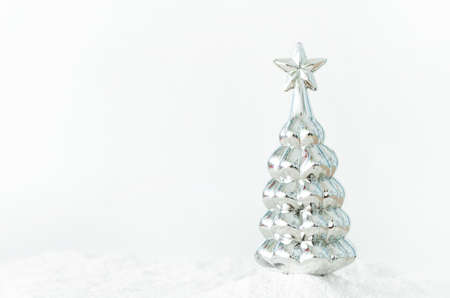 Shiny Christmas toy in the shape of Christmas trees in the snowの写真素材