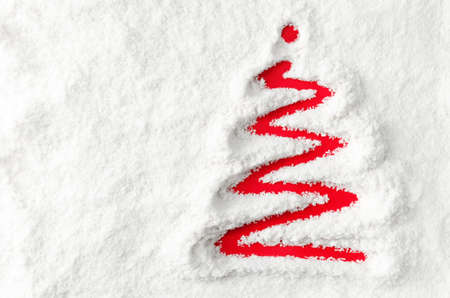 Red Christmas tree drawn on white snowの写真素材