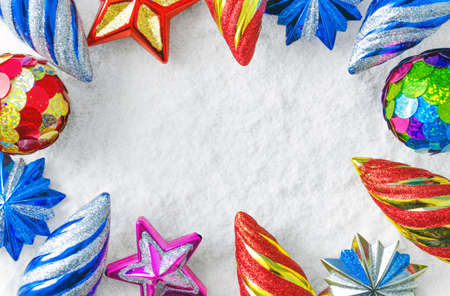 Multi-colored Christmas toys on a background of snowの写真素材