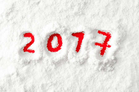 New Year red numbers 2017 on the white snowの写真素材