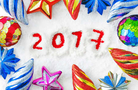 Multi-colored Christmas toys on a background of snowの写真素材