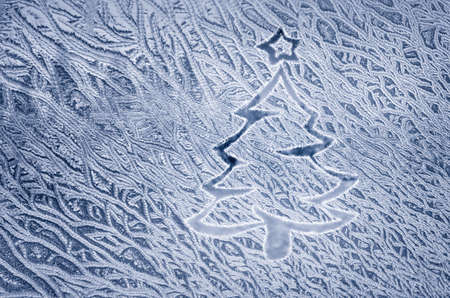 Christmas tree in the painting on frozen glass