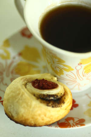 cup of coffee and a sweet rollの写真素材