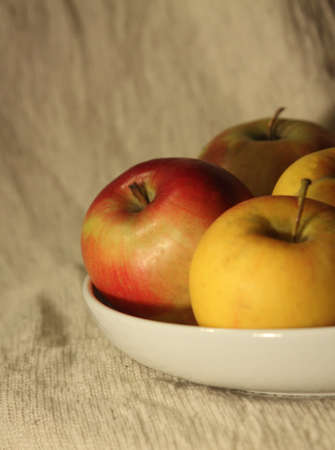 apples on a plate against light backgroundの写真素材